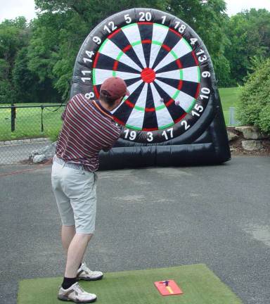 Young participant tries to score in Dart Golf Contest.