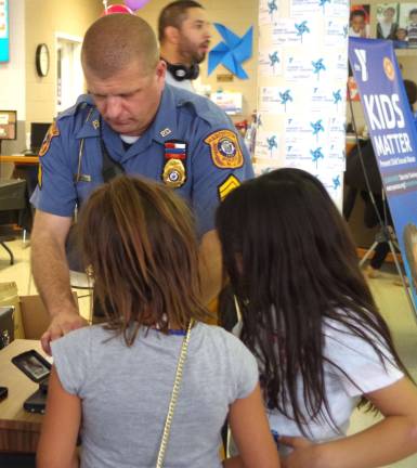Hardyston Township Police Department Sergeant Edward O'Rourke spent much of the day fingerprinting children during the YMCA&#xfe;&#xc4;&#xf4;s Healthy Kids Day. The fingerprint sheets were given to the parents for safekeeping in the event an emergency might arise.