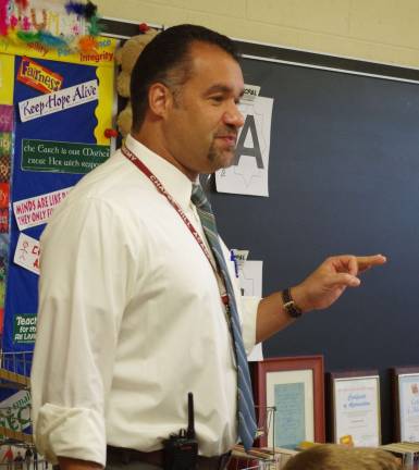 Assistant Principal Eric Kosek is shown welcoming students. His presentation included a combination of wisdom and levity.