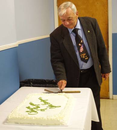 Citizen of the Year John Harrigan made the initial cut in the cake acknowledging his achievements.