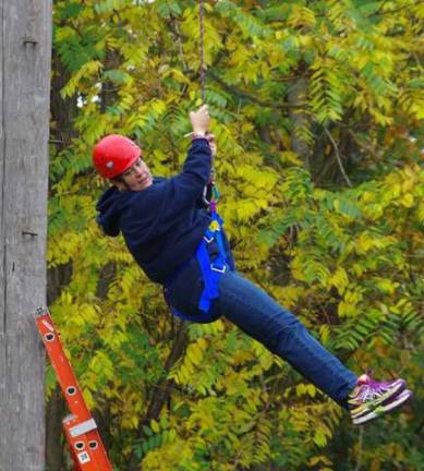 Guidance Counselor Laura Merck started her aerial adventure by balancing as she crossed a not-so-tight tightrope while trusting her belayer to protect her if she fell and then safely lower her back to the ground below.
