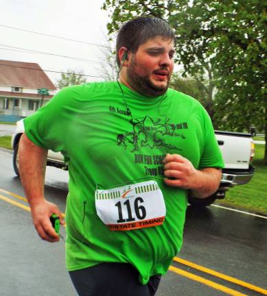 Michael Bencivenga, 24, of Hamburg heads toward the finish line in the rain at the One Step Closer Animal Rescue 5K.