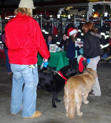 Canines and their people line up for the finished photos with Santa.