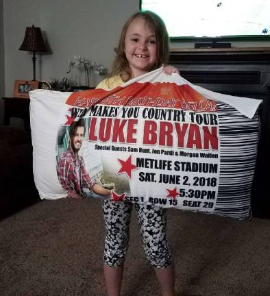 Bella Valerius is shown with a pillow from the June 2 Luke Bryan Concert at MetLIfe Stadium on June 2.
