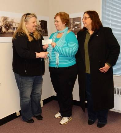 Photo courtesy Jessi Paladini Vernon Township Historical Society Treasurer Nancy Adam and Society Trustee Doreen Edwards, right, presenting a check to VFW Treasurer Cindi Auberger.