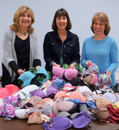 PHOTOS BY VERA OLINSKI From left, Karen Rothstadt, Anne Whitty, and President Lisa Mills stand behind some of the over 1,200 bras the Vernon Township Women's Club will send to help victims of human trafficking.