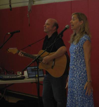 Kira Willey, yoga, songwriter and movement instructor and Leo ask students to assume a mountain pose.