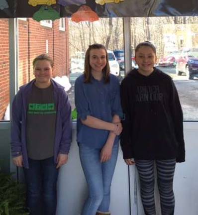 The three individual winners of the Great Kindness Challenge pose under the contest race track, used to track the students&#xfe;&#xc4;&#xf4; acts of kindness. From left, Gia Bonard, Jade Lally, and Hannah Panzarella.