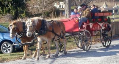 Bundled against the cold, visitors take a nostalgic horse drawn carriage ride.