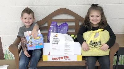 Pictured are Logan Yuhas and Brooke Collura from Ms. Roy's Kindergarten class helping with the items already collected.