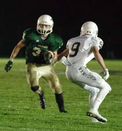 Sussex Tech ball carrier Brendan Hall tries to run past Wallkill Valley defender Evan Faner in the first half.