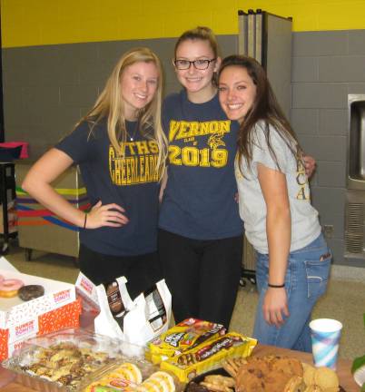 Three DECA members (from left) Morgan Hinchman, Emily Talt and Brielle Eilinger help feasters make a dessert selection.
