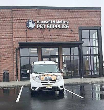 The Maxwell &amp; Molly’s van sits in front of the new store. The van has seen a lot of action during the pandemic delivering pet supplies (Photo by Laurie Gordon)