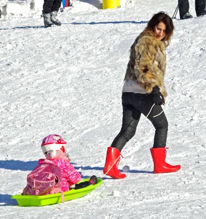 Visitors from New York City enjoy a little sledding behind the Red Tail Lodge.