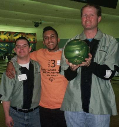 Sharing a light moment at the Area 3 Special Olympics Bowling Competition at Hanover Lanes are, from left, Special Olympics athlete Joe Ellis of Byram, Special Olympics volunteer Carlos Delrio of Passaic, a student at William Paterson University; and Special Olympics athlete Sean Carroll of Sussex.