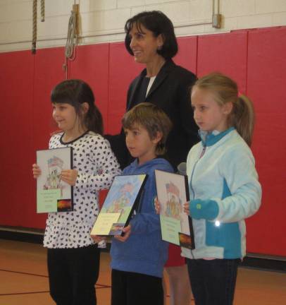 Principal Rosemary Gebhardt poses with winners of the coloring contest.From left are Taylor Enright, Adam Jaros and Hannah Potzer.