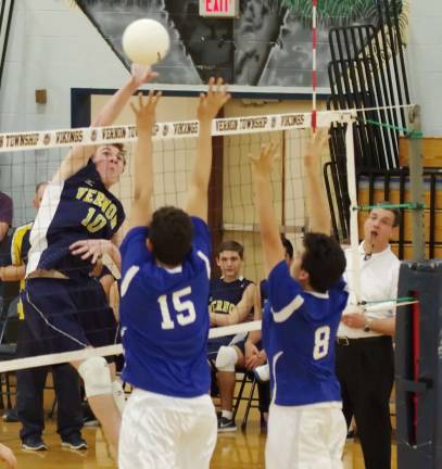 Vernon's Ethan Kolonoski (10) strikes the ball as two Central Jersey Cougars rise to challenge.