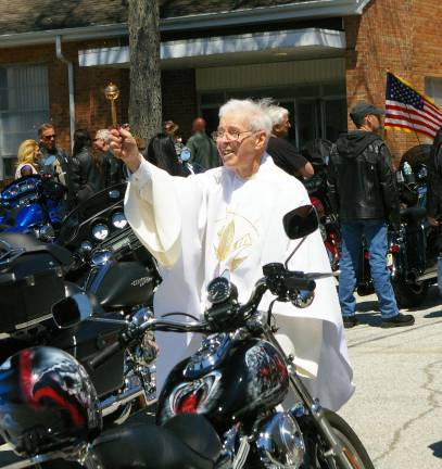 Monsignor Robert Carroll, Father Bob, blesses the motorcycles and people at Our Lady of Fatima's 15th annual Biker Blessing.