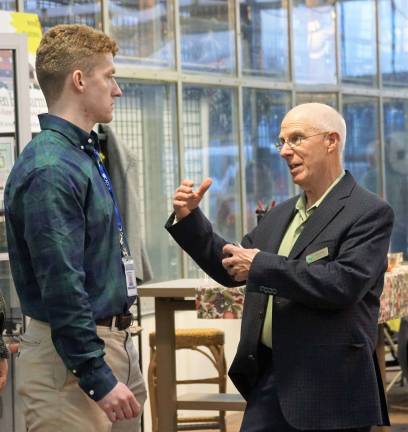 From right, Vernon Chamber of Commerce President Elmer Platz speaks with Vernon Coalition Youth Coordinator Conor Brennan.