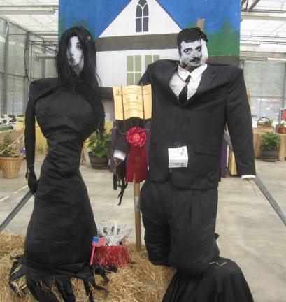 Scarecrow winners Morticia and Gomez Adams were creatively constructed in the greenhouse area of the fair.