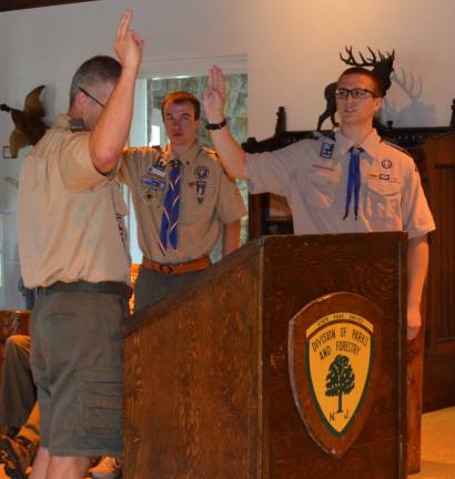Eagle Scout Eric Sives, former Advancement Chair and Cubmaster for Troop and Pack 84, administers the Eagle Scout Oath of Honor to Joe Mitchell as Eagle Scout Tim Mitchell looks on.