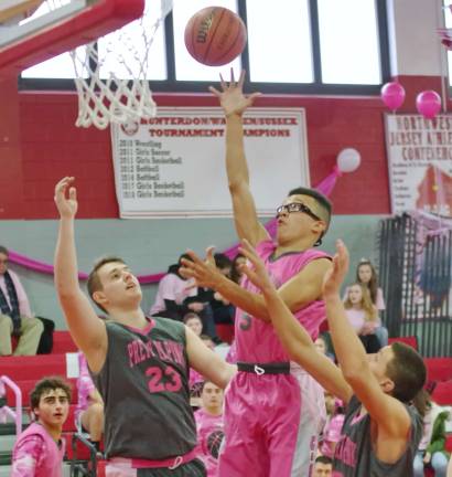 Vernon's James Pellott (glasses) tosses the ball towards the basket during a leaping shot. Pellott scored two points and grabbed four rebounds.