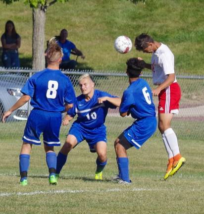 Far right the ball bounces of of the head of High Point's Thomas Watts (red shorts) as he performs a header.