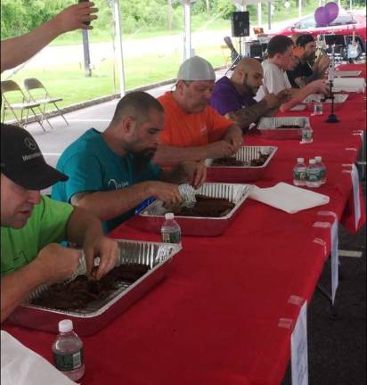 Vinny Pronesti (blue shirt) ate one full rack of ribs the fastest to win the 8th annual &quot;Rock, Ribs &amp; Ridges Rib Eating Challenge&quot; which benefits local charities and non-profit organizations courtesy of the upcoming Rock, Ribs &amp; Ridges festival June 23-24 at the Sussex County Fairgrounds in Augusta.