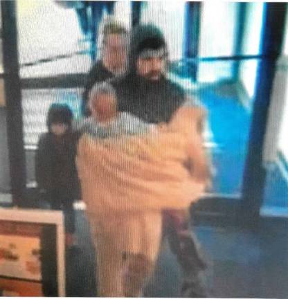 Surveillance cameras caught the suspects accompanied by two small children (Photo provided)