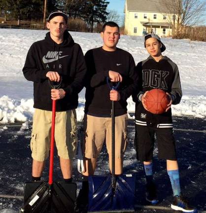 This photo provided by Vernon Recreation Director Melissa Wiedbrauk shows, from left, Brady Keenan, 16, Brandongene Kon, 17 and Chase Davenport, 15, who said they were determined to play basketball and shoveled off a court on Thursday, March 12. &quot;I kept thinking how after a long day at school these three guys wanted to shoot hoops and made it happen, which of course brightened my entire day,&quot; Wiedbrauk said.