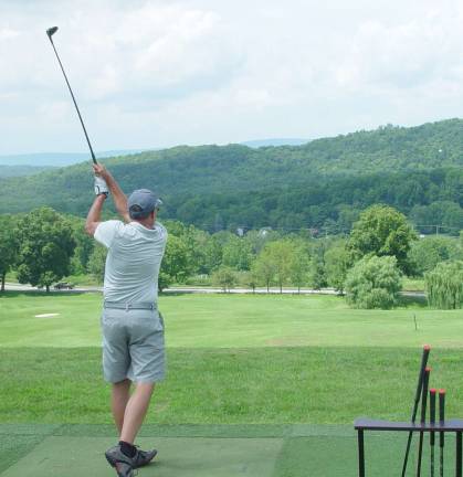 Golfer warms up at the Practice Range at the Wild Turkey Golf Course for the 3rd Crystal Cup Tournament.