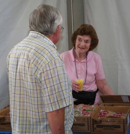 Senior volunteer Shirley Baldwin of Vernon offered snacks for the visiting seniors.
