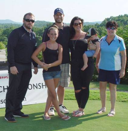 The Sanborn family of wife, Christy, daughter, Lenna, and new son West accompany Event Coordinator Dave Lurin and golfer Buffy Whiting prior to taking part in the Long Drive Qualifier at Black Bear Golf Club.