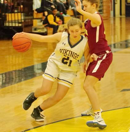 Vernon's Tori Waschek dribbles the ball as she pushes past a Madison defender.