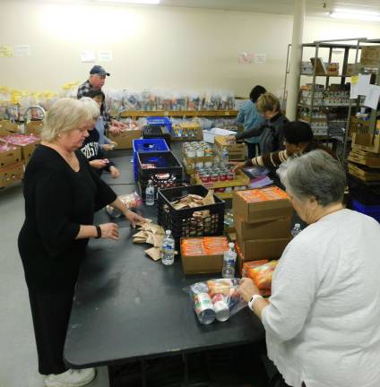 PHOTO BY MANDY CORISTON Volunteers from the Panther Valley Ecumenical Church pack &quot;weekend bags&quot; at the Sussex County Food Pantry on Thursday, Jan. 17, 2019. The bags are distributed to four local school districts to help food insecure students fill the food gap between meals at school.
