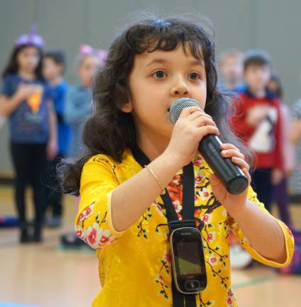 Cedar Mountain students show their talents Melissa sings "The Star Spangled Banner."