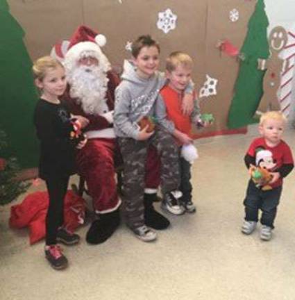 The Vaughn family pose with Santa.