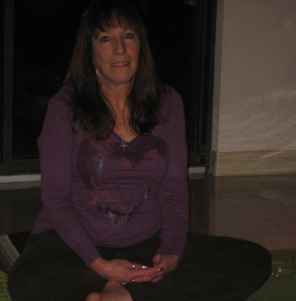 namaste, everyone Certified yoga instructor Donna Maher prepares for her class in the social hall of St. Francis de Sales Church.