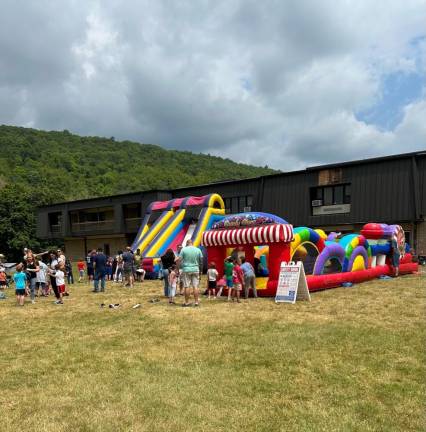 Children play in inflatables at Vernon Day.