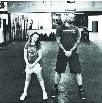 Photos provided Bob Harper, Trainer Bob from the Biggest Loser, wearing a #shutupandlift shirt and his niece wearing out &quot;Pullups cleans kettlebell swings that's what girls are made of&quot; burnout shirt.