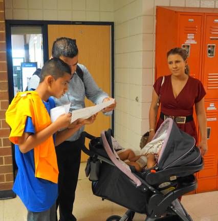 Father and son examine the upcoming school schedule