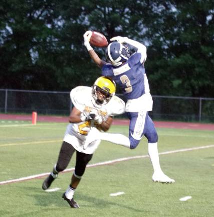 Stags wideout Yusef Reddick makes a leaping catch against tight coverage by Knights defender Jihad Myers in the second quarter.