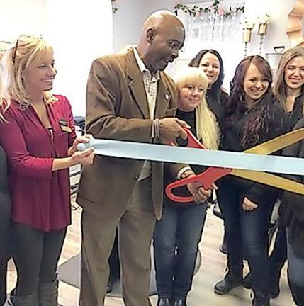 Vernon Township Mayor Howard Burrell cuts the ribbon at Magnolia' Beauty Boutique.