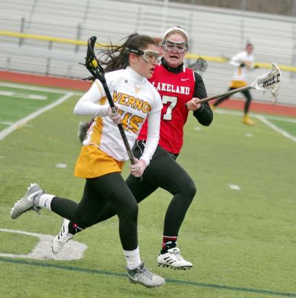 Vernon's Briana Garcia advances the ball as Lakeland's Danielle Downey keeps pace.