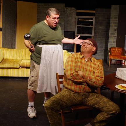 Wearing an apron, Thom Penny of Newton portrays the part of Felix Ungar while Vernon resident Tim Mullally plays the part of Oscar Madison during a rehearsal of &quot;The Odd Couple&quot;.