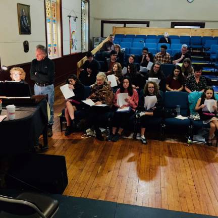 Sandy Salter at the piano and director Jeffrey Stocker (far left) are pictured rehearsing with cast members (Photo provided)