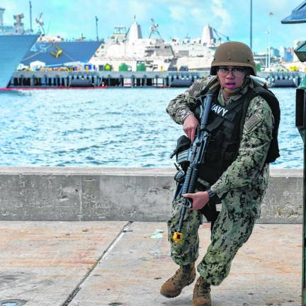 It’s only a drill Logistics Specialist 2nd Class Juan Bautista, a native of Vernon who is assigned to the USS Boxer, responds during an anti-terrorism force protection drill. The Boxer is a Wasp-class amphibious assault ship homeported in San Diego. (Photo by Seaman Tyler Miles)