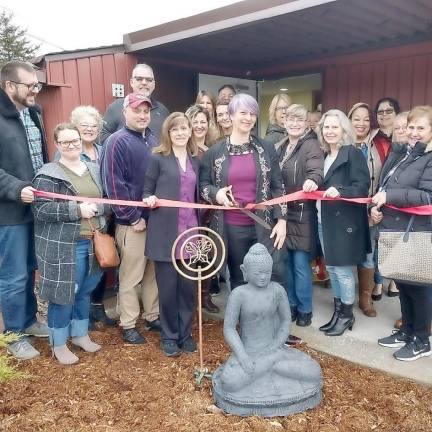 Photographed in center is Garden of Life Massage owner &amp; Licensed Massage Therapist, Dawn Gomez cutting the grand opening ribbon surrounded by staff, family, &amp; friends of Garden of Life.