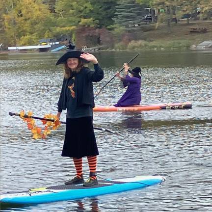 Highland Lakes hosts Witch and Warlock Paddle <b>“Witch” Robin Wolf waves to onlookers as she sails off on her paddle.</b>