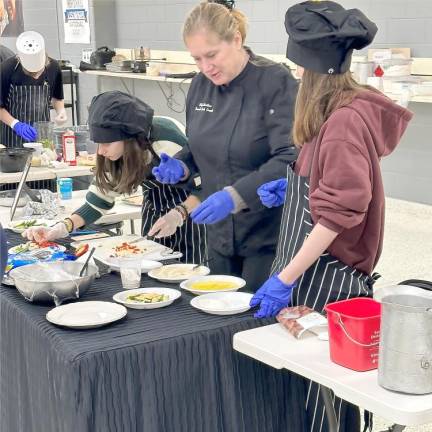 The Bubble Guppies team prepares their meal.